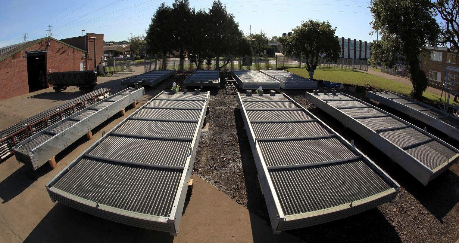 Air cooled heat exchanger panels arranged in a manufacturing setting